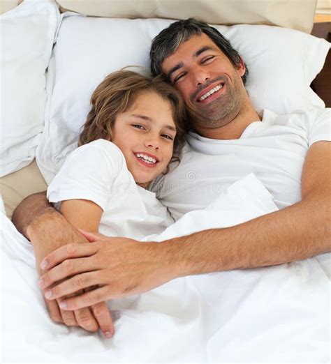 Loving Father Hugging His Son Lying On The Bed Stock Image Image Of