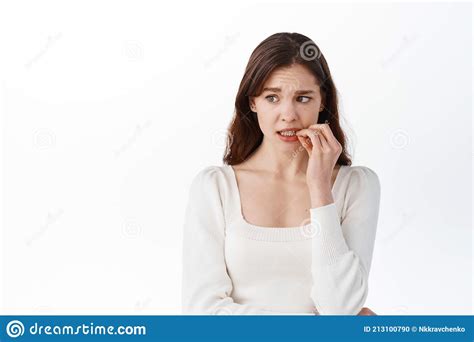 Nervous Girl Biting Fingers And Looking Aside With Anxious Panicking Face Woman Making Small