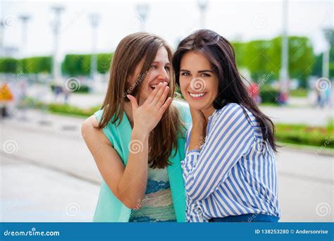 Two Young Women Talking To Each Other Stock Photo Image Of Leisure