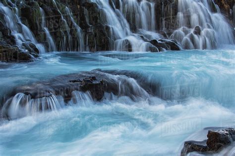 Water Cascading Over Rocks Into A Turquoise River Bruarfoss Iceland