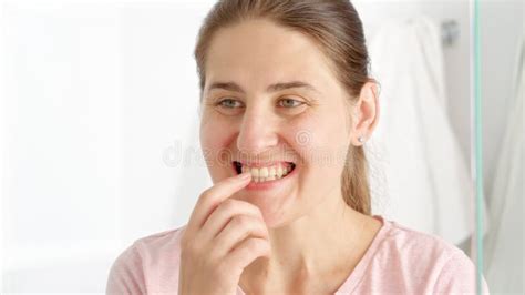 Portrait Of Happy Smiling Woman Standing In Bathroom And Checking Her