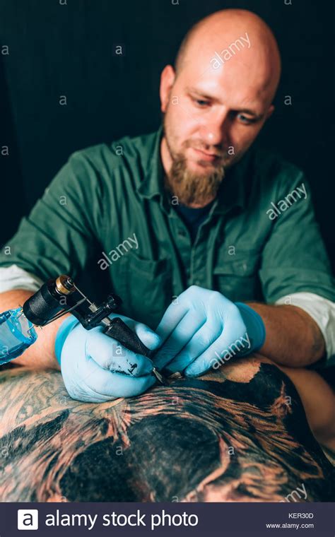 Tattoo Master Artist Makes A Tattoo Closeup Stock Photo Alamy