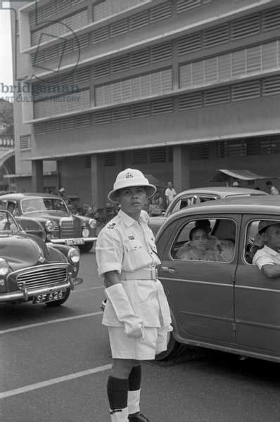image of traffic policeman directing traffic in a street of singapore singapore