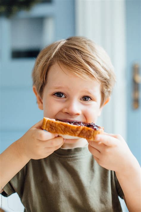 Young Boy Eating Toast With Jam For Breakfast by Marko - Breakfast, Family