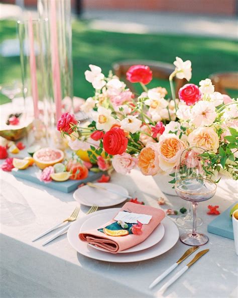 The Table Is Set With Flowers And Plates