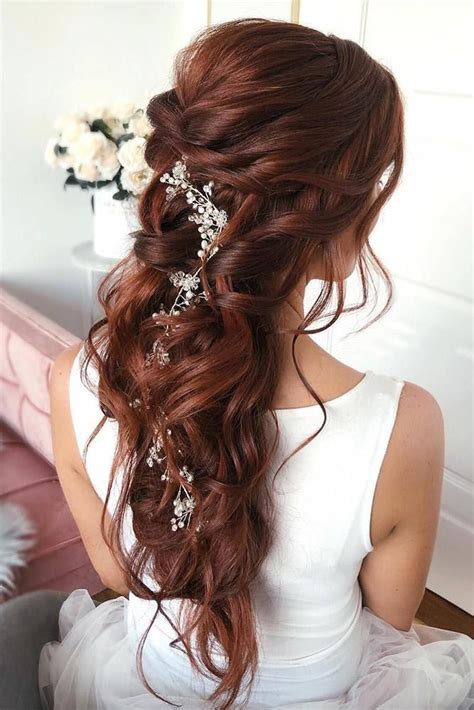 Full curls throughout the lengths are contrasted by smoothness up top and simple twists on the sides pulled back from the front. 25 Amazing Half Up Half Down Wedding Hairstyles - ChicWedd