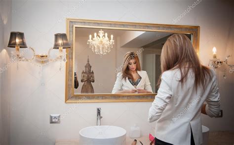 Sensual Elegant Woman In Office Outfit Looking Into A Large Mirror