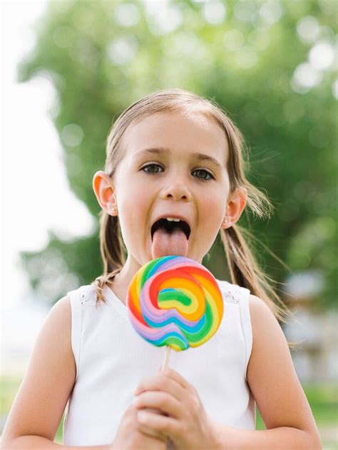 Girl Licking Colorful Lollipop License Images Stockfood