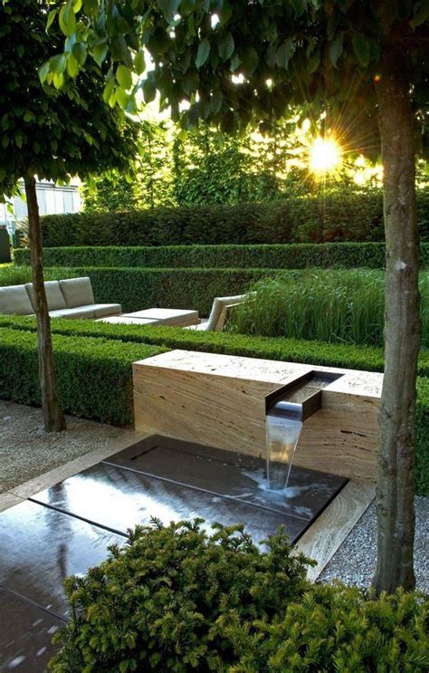 Modern Patio With Small Waterfall And Rill Patio Box Hedge Seating Area