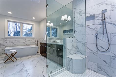 Incredible Master Bathroom With Carrara Marble Tile Surround Stock