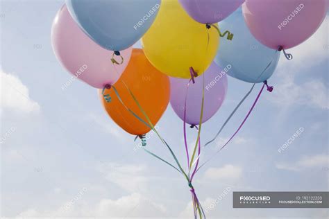 Bunch Of Colorful Balloons Floating In Air Against Blue Sky — Outdoors