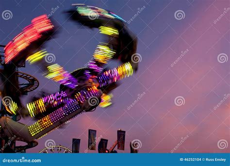 colorful lights of carnival ride motion blur at dusk editorial stock image image of colorful