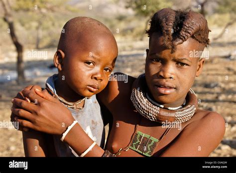 Himba Girl With Baby Brother Village Near Opuwo Namibia Stock Photo