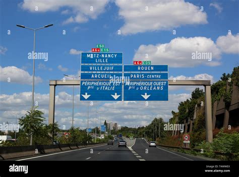 Big Road Signs Of The Busy French Highway That Reaches Paris And Other