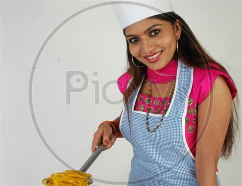 Image Of An Indian Woman Cooking Jalebi Or Jilebi Sweet On An Isolated White Background Au436657