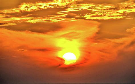 Fiery Sunrise Through The Wispy Morning Clouds Photograph By C Sev