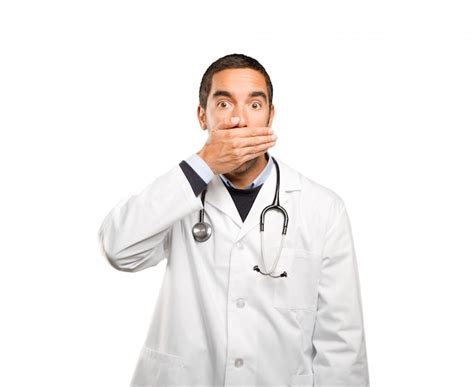 Premium Photo Shocked Doctor Covering His Mouth Against White Background
