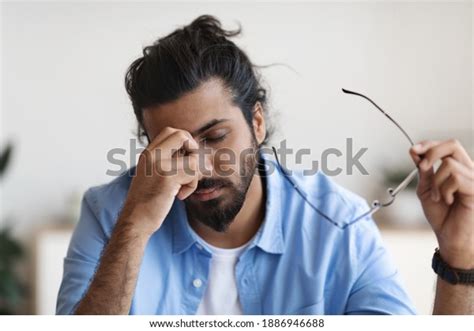 Exhausted Young Arab Man Taking Off ภาพสต็อก 1886946688 Shutterstock