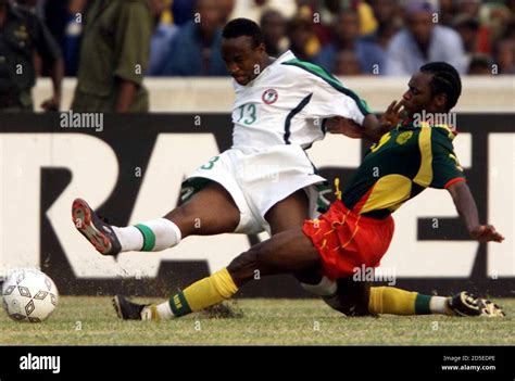 Pierre Wome R Of Cameroon Fights For The Ball With Tijani Babangida