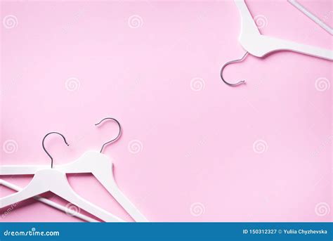 White Clothes Hangers On Pink Background With Copy Space Flat Lay Top