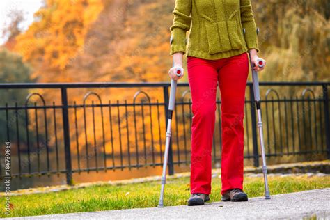 Woman Practicing Walking On Crutches Stock Photo Adobe Stock