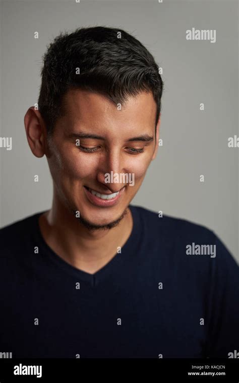 Happy Shy Young Hispanic Man Smiling And Look Down Stock Photo Alamy