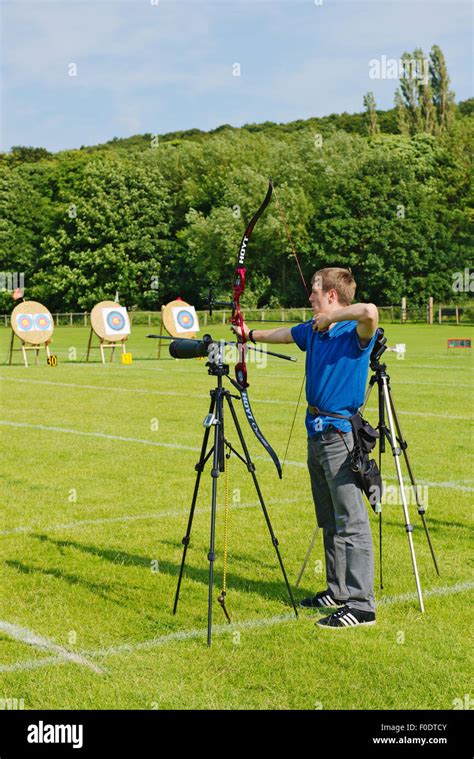 Man Shooting Modern Recurve Bow At Target In Archery Competition West