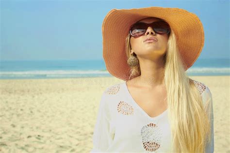 Beautiful Blond Woman On The Beach In The Hat And Sunglasses Stock
