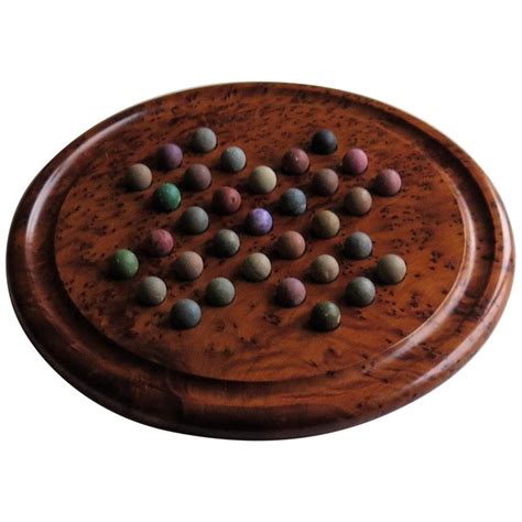 Choose one of two games, the more common 32 marble puzzle or the 36 marble game. Large Marble Solitaire Board Game with 33 Early Handmade Clay Marbles For Sale at 1stDibs
