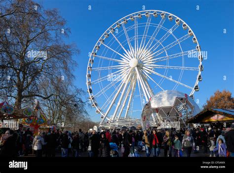 Visitors At The Winter Wonderland Funfair Below The Wheel Of Hyde Park