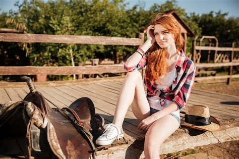 Premium Photo Relaxed Redhead Young Woman Cowgirl Sitting And Resting
