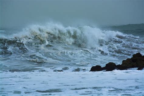 Sea Storm Waves Dramatically Crashing And Splashing Against Rocks Stock