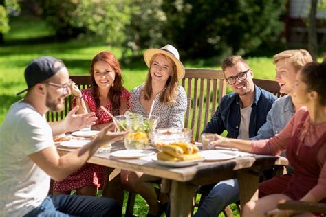 Happy Friends Having Dinner At Summer Garden Party Stock Photo Image
