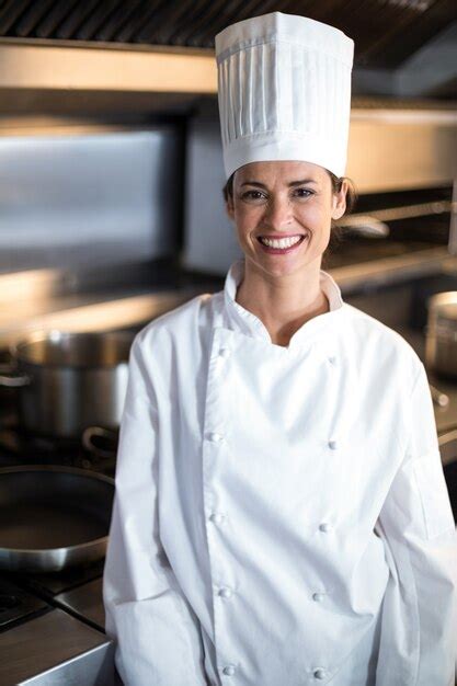 Premium Photo Portrait Of Smiling Female Chef Standing In Kitchen