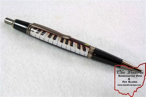 A Black And White Piano Key Pen With Silver Trim