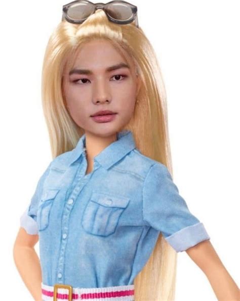 A Barbie Doll With Blonde Hair And Sunglasses On Her Head Wearing A Blue Shirt