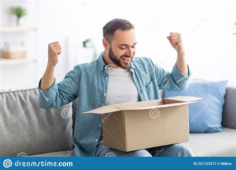 Satisfied Male Client Opening Box Excited Over Delivery Service