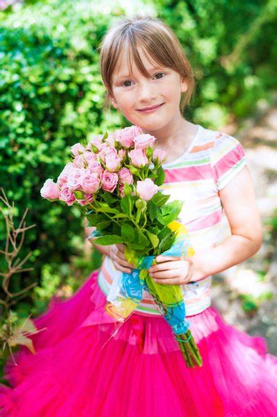 Little Girl With Peony Flowers In The Garden — Stock Photo © Famveldman