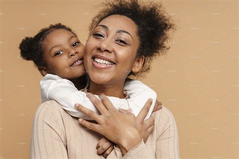 happy black mother and daughter hugging and smiling people images ~ creative market