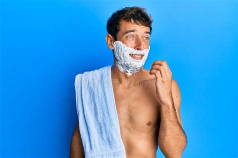 Handsome Man Saving Beard With Shave Foam Over Face Looking Stressed