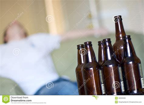 Man Passed Out On Couch With Empty Beer Bottles Angled Royalty Free