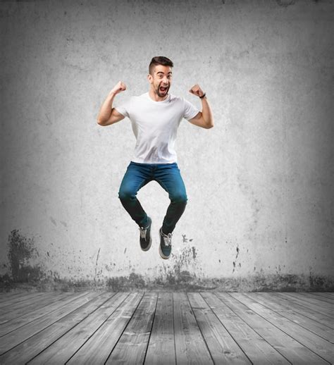 Happy Man Jumping On The Wooden Floor Photo Free Download