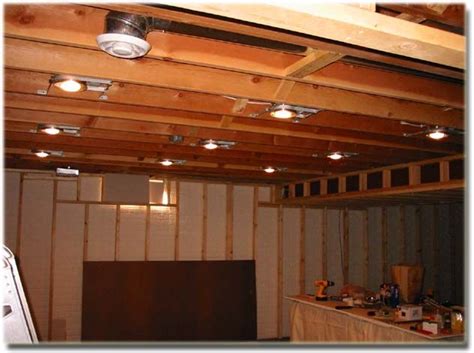An Unfinished Room With Wood Paneling And Lights On The Ceiling Is