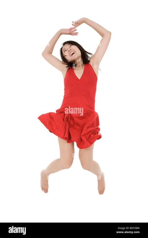 Beautiful Asian Woman In A Red Sun Dress Posing On A White Background