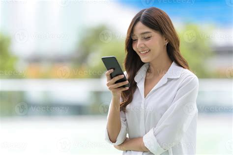 Outdoors Portrait Of Happy Young Woman Using A Phone 2635662 Stock