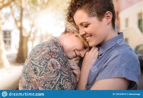 Smiling Young Lesbian Couple Sharing An Affectionate Moment Together Outside Stock Image Image