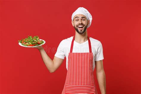 Excited Young Bearded Male Chef Cook Or Baker Man In Striped Apron Toque Chefs Hat Posing