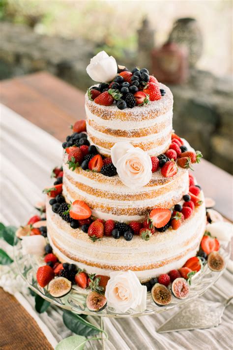 naked wedding cake with berries and roses