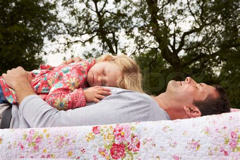 father with daughter relaxing on camping holiday stock image colourbox