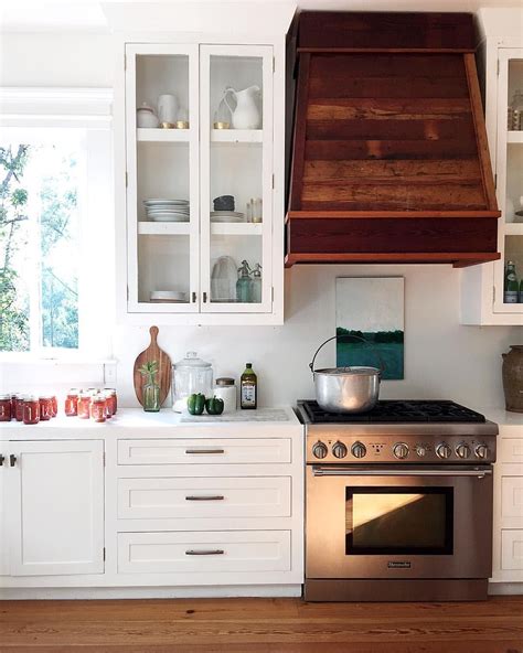 More can be seen in our complete catalog. white kitchen + wood range hood | Kitchen layout, Wood ...